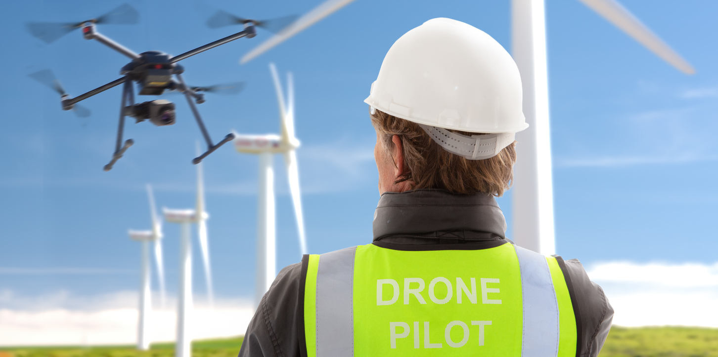 professional drone operator engineer inspecting wind turbines